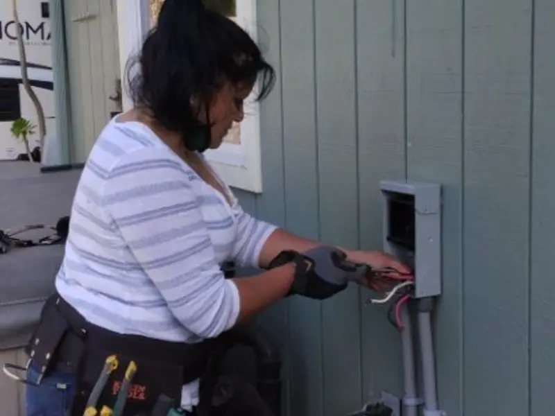 Licensed electrician wiring an exterior subpanel in Faribault